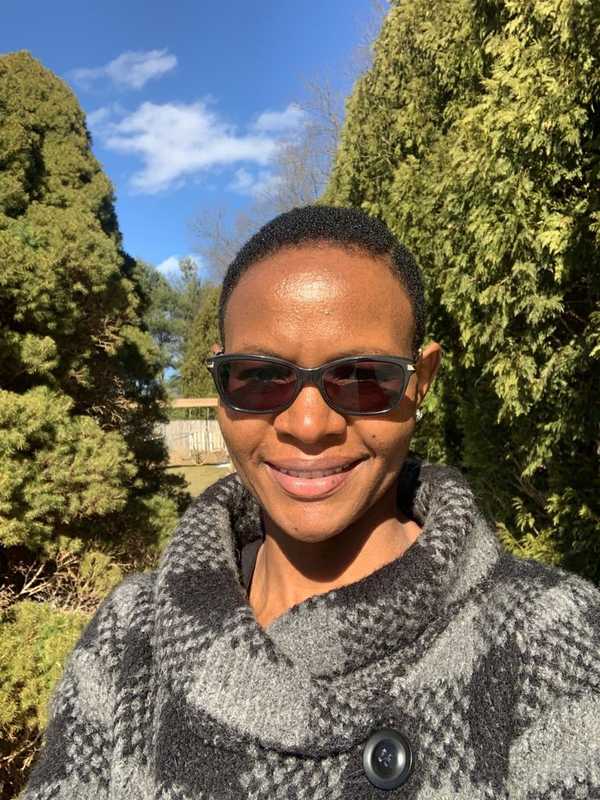 Esther Kamau with sunglasses outside